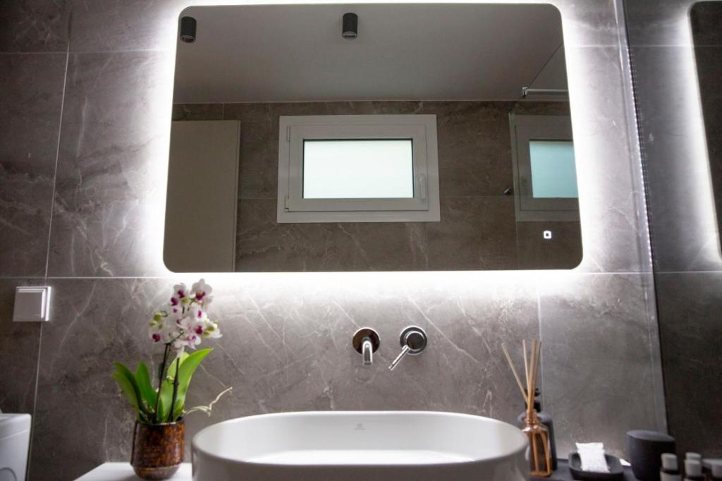 Backlit LED bathroom mirror at Nerissa seafront apartment
